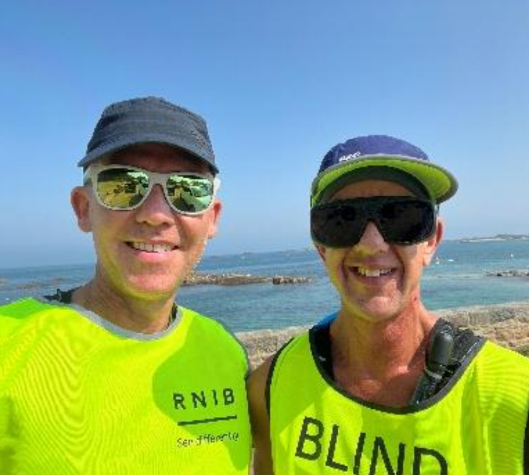 Michael Ellis and his running guide Gus on the seafront in Guernsey